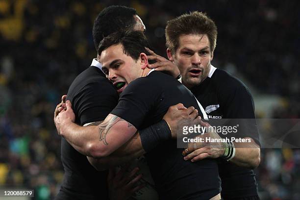 Zac Guildford of the All Blacks celebrates with Jerome Kaino and Richie McCaw after scoring a try during the Tri-Nations match between the New...