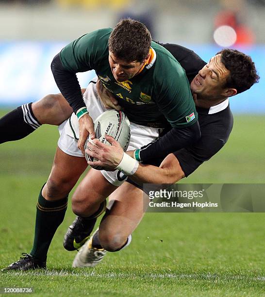 Morne Steyn of South Africa is tackled by Dan Carter of the All Blacks during the Tri-Nations match between the New Zealand All Blacks and the South...