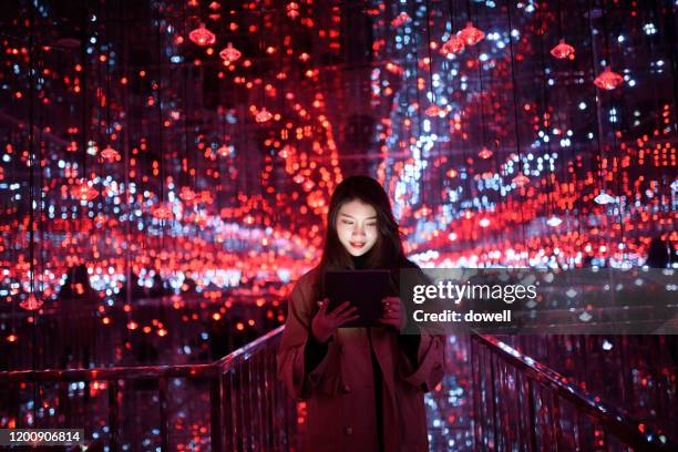 young aisan female using digital tablet - aisan women stock pictures, royalty-free photos & images