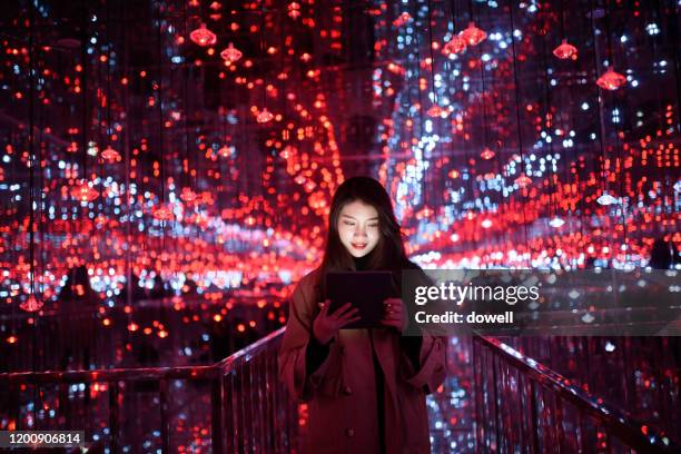 young aisan female using digital tablet - technology asia stock pictures, royalty-free photos & images