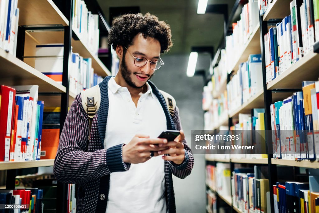 Library Study Phone Student Using Smartphone While Looking For Books In Library High-Res ...