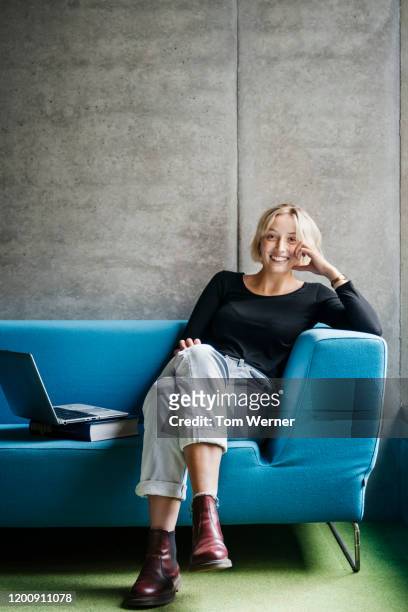 portrait of library patron sitting on couch - legs crossed at knee stock pictures, royalty-free photos & images