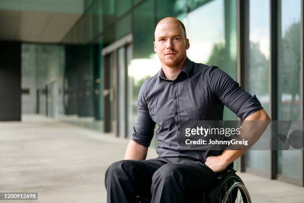 outdoor portrait of young businessman in wheelchair - wheelchair stock pictures, royalty-free photos & images