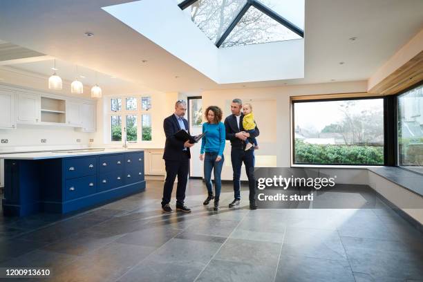 house viewing - young family in kitchen stock pictures, royalty-free photos & images