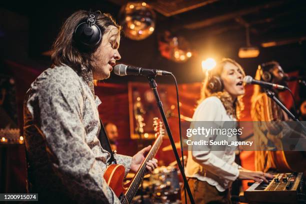 music band performing on stage - pop music stock pictures, royalty-free photos & images