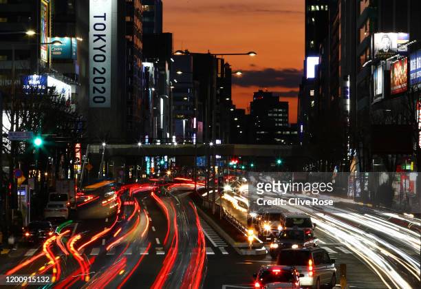 Rush hour traffic is seen passing a Tokyo 2020 promotional display in the Aoyama district of Tokyo on January 21, 2020 in Tokyo, Japan.