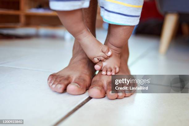 playful feet are happy feet - kids feet in home stock pictures, royalty-free photos & images
