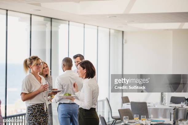 work colleagues taking lunch break during business seminar - business lunch stock pictures, royalty-free photos & images