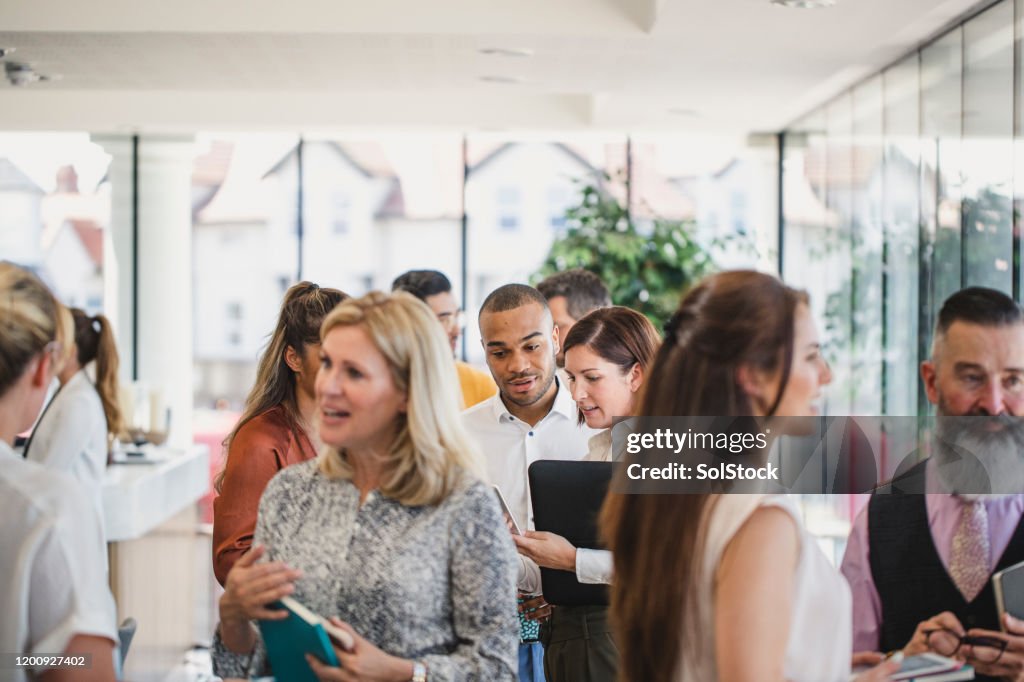 Work colleagues meeting and talking in corporate building
