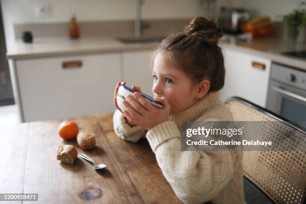 a 6 year old girl having her breakfast - winter breakfast stock pictures, royalty-free photos & images