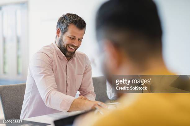 cheerful mature businessman smiling in meeting - differential focus stock pictures, royalty-free photos & images