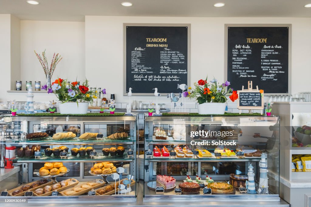 Cafe counter containing cakes and desserts for sale