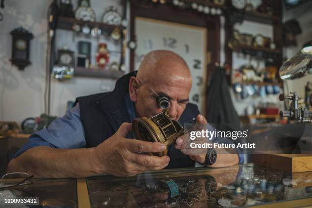 watchmaker repairing old clock - clock repair stock pictures, royalty-free photos & images