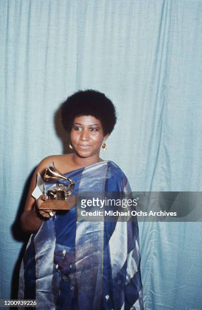 American singer, songwriter, pianist, and civil rights activist Aretha Franklin holding her award for 'Best Female R&B Vocal Performance' at the 13th...