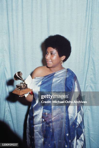 American singer, songwriter, pianist, and civil rights activist Aretha Franklin holding her award for 'Best Female R&B Vocal Performance' at the 13th...