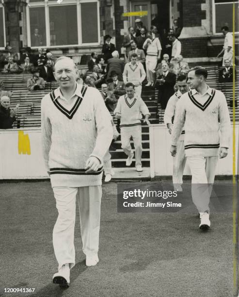 The captain of Surrey CCC Stuart Surridge , leading his team out for a match at The Oval, 8th September 1956.