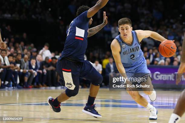 Collin Gillespie of the Villanova Wildcats in action against Alterique Gilbert of the Connecticut Huskies during a college basketball game at Wells...