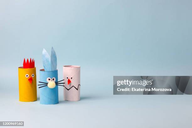 Paper toy Happy Easter home party. Easy crafts for kids on blue background, copy space, die creative idea from toilet tube roll, recycle reuse eco concept, kindergarten daycare