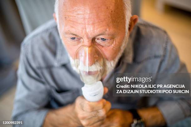 senior inhalation therapy in progres. - emphysema stock pictures, royalty-free photos & images