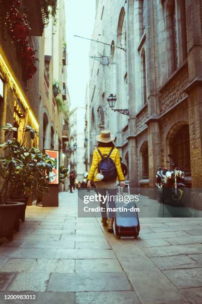 tourist visiting spain - yellow suitcase stock pictures, royalty-free photos & images