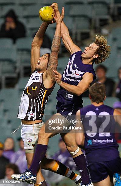 Chris Mayne of the Dockers spoils Lance Franklin of the Hawks during the round 19 AFL match between the Fremantle Dockers and the Hawthorn Hawks at...