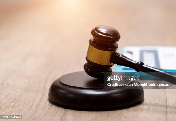judge gavel and scale in court. legal concept - auction hammer stock-fotos und bilder
