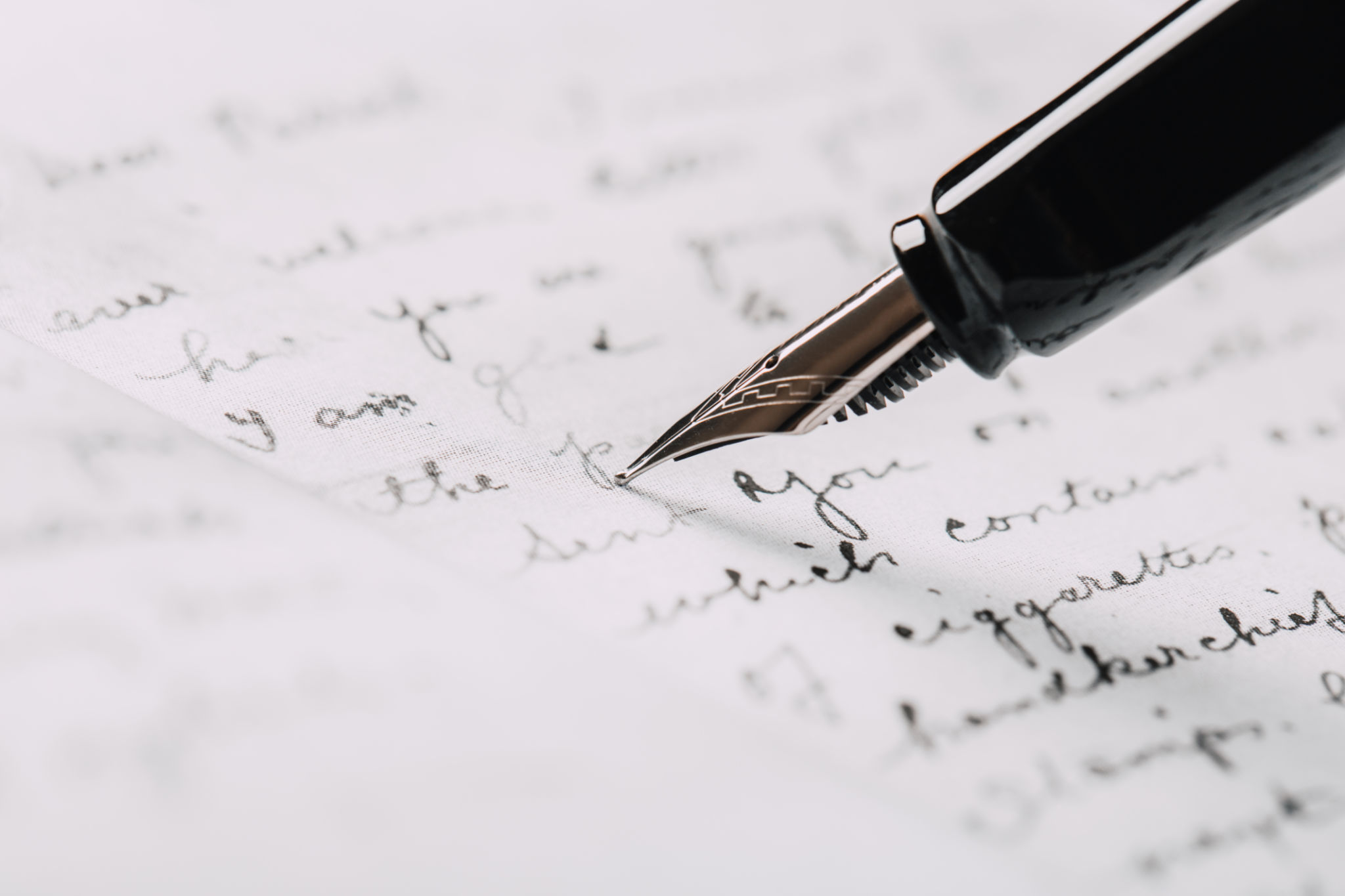 fountain pen on paper with ink text closeup fountain pen on paper with ink text closeup