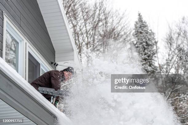 senior man shoveling snow in winter after snowstorm - winter snow shovel stock pictures, royalty-free photos & images