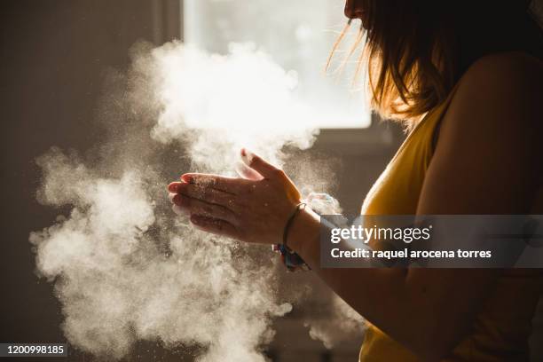 woman using magnesium on his hands to climb - sports chalk stock pictures, royalty-free photos & images