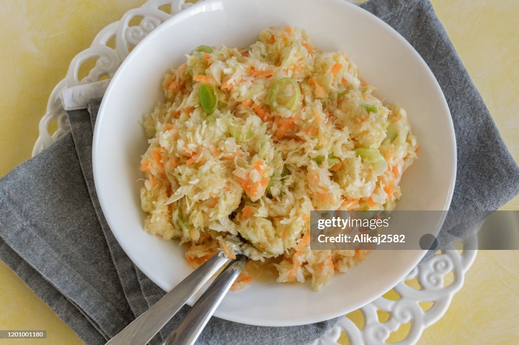 Fresh salad of raw cabbage, leeks and carrots, multivitaminico natural food