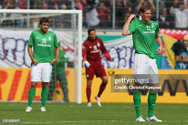 Sokratis Papastathopoulos, Tim Wiese and Tim Borowski of Bremen look dejected after the first goal of Heidenheim during the first round DFB Cup match...