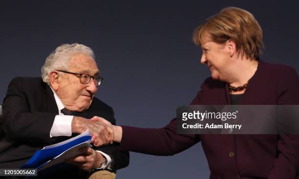German Chancellor Angela Merkel and former United States Secretary of State and National Security Advisor Henry Kissinger attend the ceremony for the...