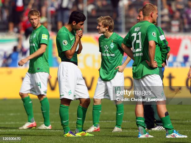 Aaron Hunt, Mehmet Ekici, Marko Marin and Andreas Wolf of Bremen look dejected after losing 1-2 the first round DFB Cup match between 1. FC...