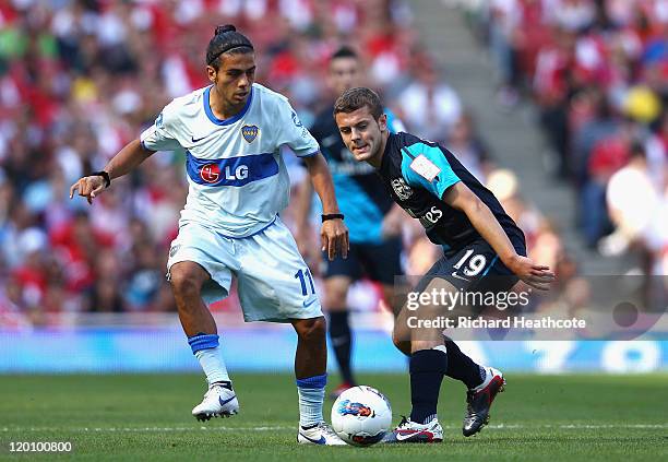 Walter Erviti of Boca Juniors and Jack Wilshere of Arsenal battle for the ball during the Emirates Cup match between Arsenal and Boca Juniors at the...