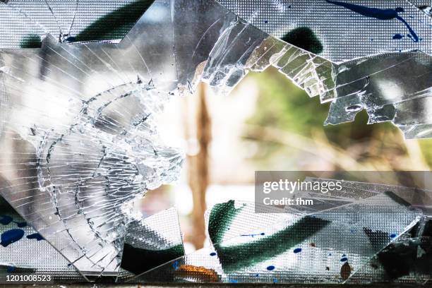 shattered window in an abandoned building - broken window stockfoto's en -beelden