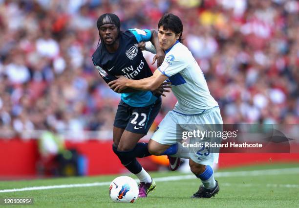 Gervinho of Arsenal and Facundo Roncaglia of Boca Juniors battle for the ball during the Emirates Cup match between Arsenal and Boca Juniors at the...