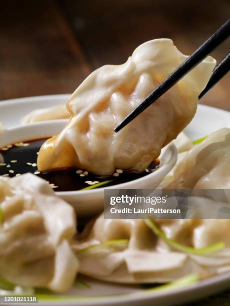 steamed asian pork dumplings with soy sauce and green onions - momo stock pictures, royalty-free photos & images