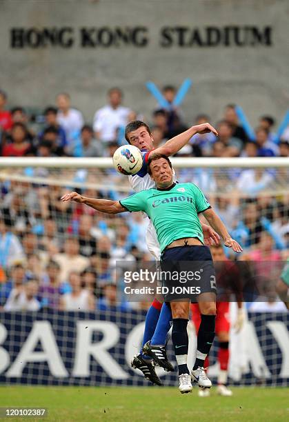 Grant Hanley of Blackburn Rovers clashes with Roberto Losada Rodriguez of Kitchee as they fight for the ball during their Barclays Asia Trophy...