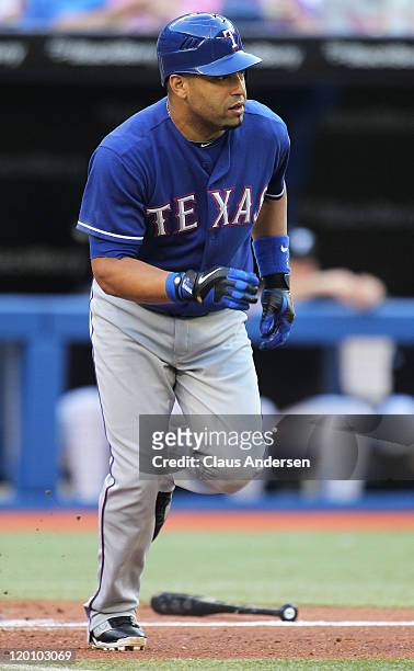 Yorvit Torrealba of the Texas Rangers bats against the Toronto Blue Jays in a MLB game on July 29, 2011 at the Rogers Centre in Toronto, Canada. The...