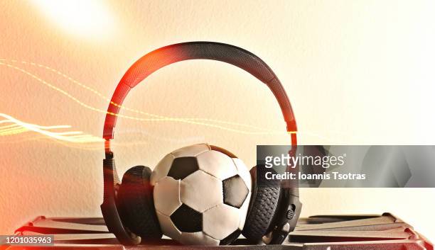 football ball with headphones - announcer stock-fotos und bilder