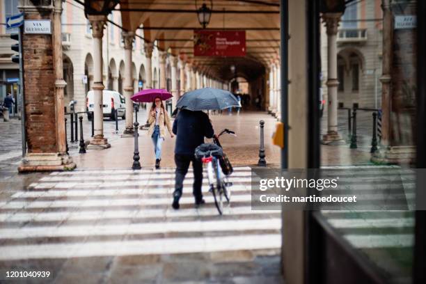 rainy day in the streets of bologna, italy. - colonnato imagens e fotografias de stock