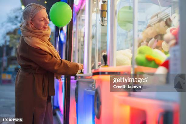 woman at amusement arcade - prater wien stock pictures, royalty-free photos & images
