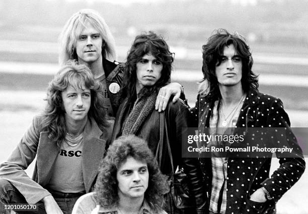 Aerosmith posing on the tarmac of Evansville Regional Airport in Evansville, IN November 7, 1977