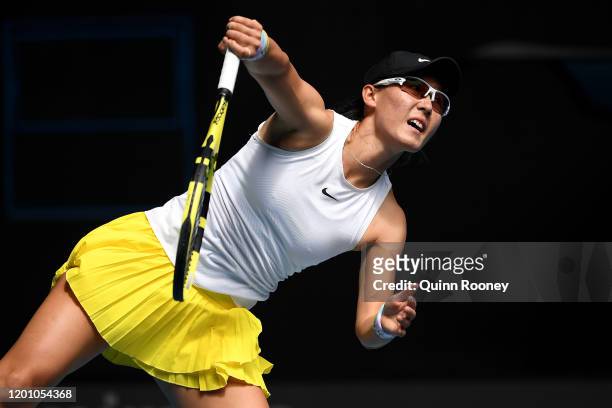 Saisai Zheng of China serves during her Women's Singles second round match against Naomi Osaka of Japan on day three of the 2020 Australian Open at...