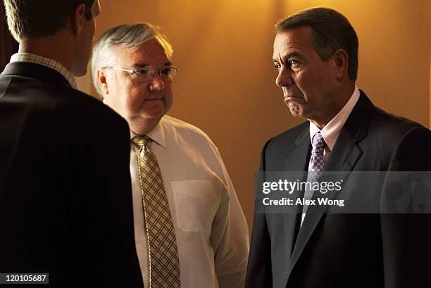 Speaker of the House Rep. John Boehner pauses as he listens to his chief of staff Barry Jackson and policy director Brett Loper at the Statuary Hall...