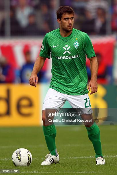 Sokratis Papastathopoulos of Bremen runs with the ball during the first round DFB Cup match between 1. FC Heidenheim and Werder Bremen at Voith-Arena...