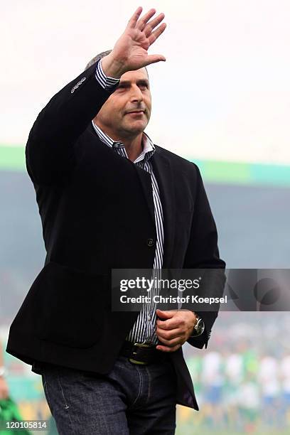 Manager Klaus Allofs of Bremen waves to the fans prior to the first round DFB Cup match between 1. FC Heidenheim and Werder Bremen at Voith-Arena on...