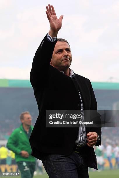 Manager Klaus Allofs of Bremen waves to the fans prior to the first round DFB Cup match between 1. FC Heidenheim and Werder Bremen at Voith-Arena on...