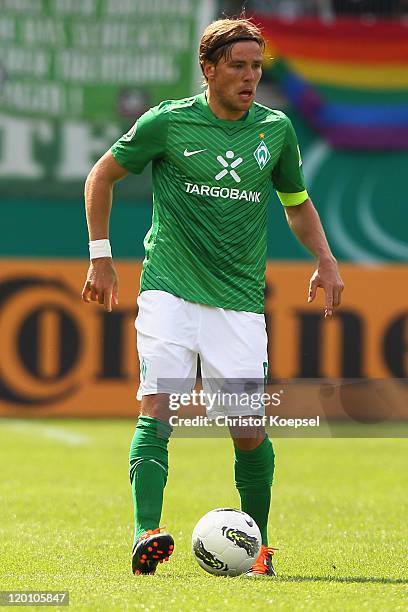 Clemens Fritz of Bremen runs with the ball during the first round DFB Cup match between 1. FC Heidenheim and Werder Bremen at Voith-Arena on July 30,...