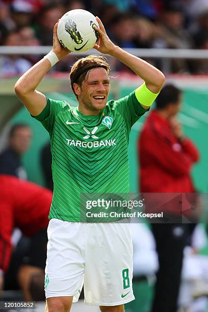 Clemens Fritz of Bremen does a throw-in during the first round DFB Cup match between 1. FC Heidenheim and Werder Bremen at Voith-Arena on July 30,...